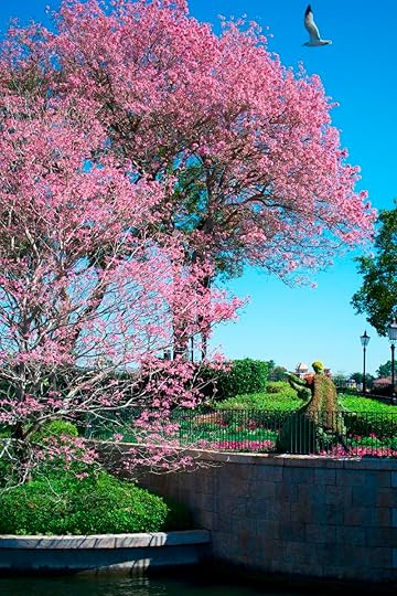 The Aurora and Phillip topiary dances under a gorgeous blooming tree near the France pavilion
