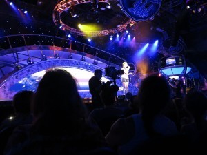 Singing her heart out under the bright lights.