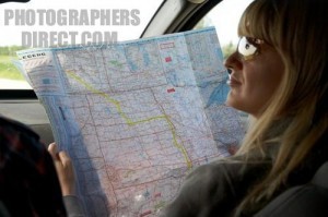 female passenger reading map and giving directions in the usa