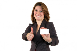 junge, lächelnde Geschäftsfrau mit business card mit Daumen hoch