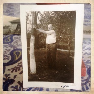 man holding up a tree