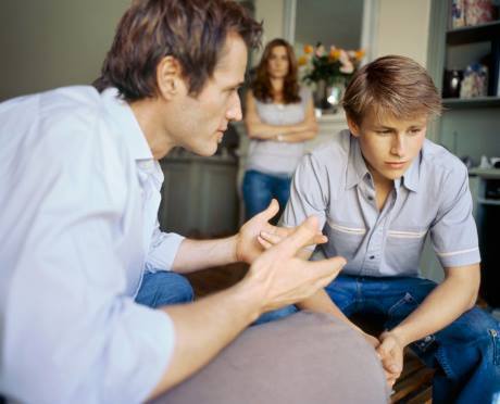 Photo of parents talking to teen about his expulsion