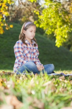 Girl meditating in the park
