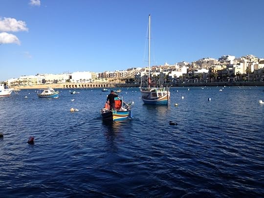 A fisherman on his way out to sea in Marsaskala, Malta