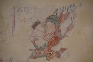 A medieval wall painting from St. Winifred's Church, Branscombe, UK, depicting an embracing couple.