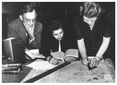 Bill Burke and Jane Mull, members of the Committee of the American Council of Learned Societies on the Protection of Cultural Treasures in War Areas, working with Gladys Hamlin, draftswoman, at the Frick Art Reference Library on a map of Paris. circa 1943-44. The Frick Collection/Frick Art Reference Library Photographs. [National Archives photograph]