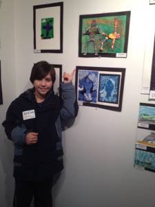 Jackson standing next to his art work.