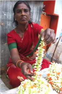 Disabled woman collecting thrown out flowers to resell