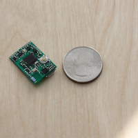 The MetaWear board next to a quarter for scale.