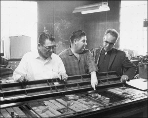 Howard Rock, left, along with Theodore Hetzel and Tom Snapp discuss printers’ type blocks and plates.