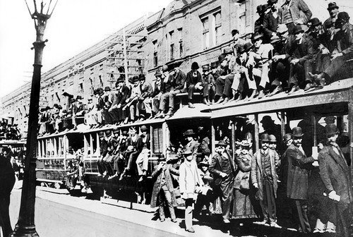 Exposition crowds were so huge at times that trains, like this one on Cottage Grove Avenue, carried an overflow of passengers on the roofs of the cars.