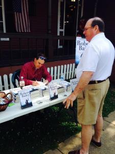 Signing a book for Clyde Butler of '66 team