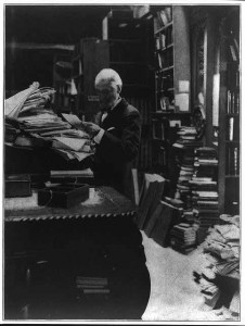 Librarian of Congress Ainsworth Rand Spofford standing amid stacks of books and library shelves. Prints and Photographs Division. 
