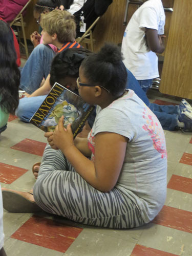 Student holding Abayomi.