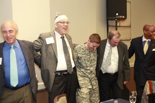 Homeland Security contractors dancing, person in uniform is Matt Howard of Iraq Veterans Against the War.