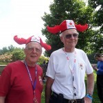 Two men in funny hats with Canadian Maple Leaves