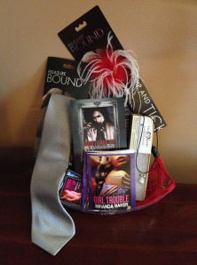 Free download of BOTTOMS UP, leather and seed pearl necklace, bondage tape, rubber flogger/tickler, THE Christian Grey tie, and swag!