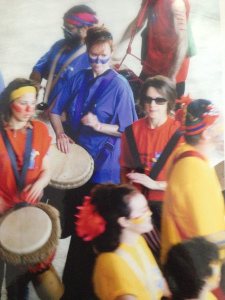 Me, in the middle in blue, participating in a public drumming performance, roughly ten years ago.