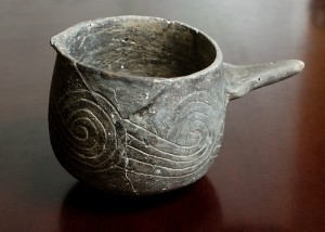 Cup related to the use of the leaves of a holly tree in a drink used for ritual purification ceremonies 