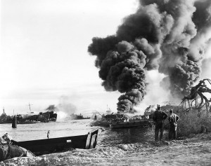 Sailors try to put out fires on LST-480 resulting from an explosion the previous day, Pearl Harbor, 22 May 1944 (US National Archives)