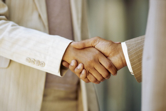 close-up of a businessman shaking hands with a businesswoman