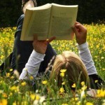 girl reading on grass
