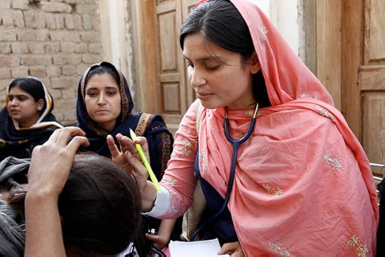 A female doctor with the International Medical Corps examines a woman patient at a mobile health clinic in Pakistan. Photo by DFID/Russell Watkins.; UK Department for International Development. CC BY 2.0 via DID Flickr