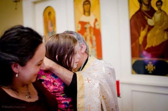 My daughter receiving her blessed cross necklace at our family's chrismation. Photo credit: Elina Pelikan