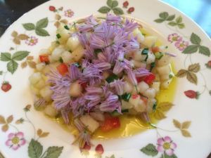 Summer salad with olive oil, ginger balsamic, and chive blossoms