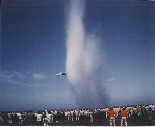 Either an F-14 nearing the speed of sound with the biggest vapor cone of all time or an F-14 demonstrating travel through folded space and time.