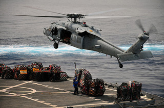 USNS Tippecanoe merchant marine prepares to attach cargo to Sea Hawk.