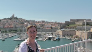 Sarah at Marseille's Vieux Port, with Notre Dame de la Garde in the background.