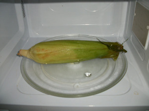 Place whole ear of corn in microwave oven.