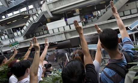 Protesters raise three fingers during an anti-coup demonstration in Bangkok on Sunday. Photograph: Sakchai Lalit/AP. Taken from The Guardian website.