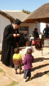 Archbishop Damaskinos giving ikon cards to some of the children who were at the service