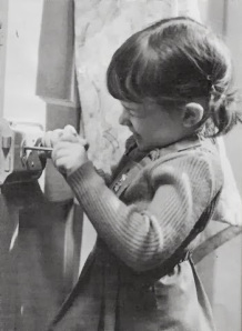 Little girl unlocking door