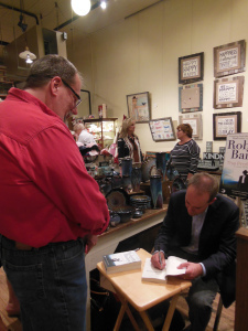 Signing a book at Harrison Brothers