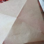 Cut a 5 1/2-inch square of parchment paper, mark the center