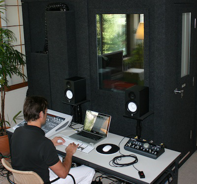 Typical voice recording studio and sound-proof booth for the talent. Gone are the days of reel-to-reel tape recorders. It's all done digitally today.
