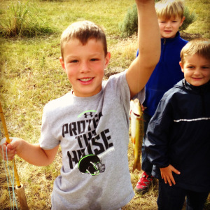 My nephew Nate shows off his first trout caught on the Old Yellow Rod. 