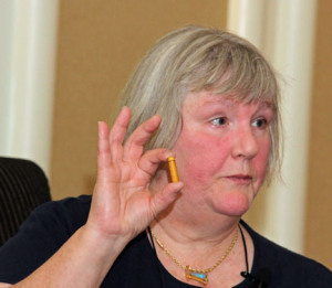 Luci Zahray, aka, The Poison Lady, holds a 24-milligram e-cigarette cartridge during her talk at Malice Domestic. Photo used with permission by G.J. Puhl.