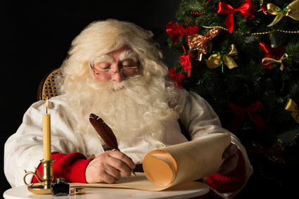 Santa Claus writing with quill