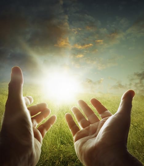 cupped hands holding light in the sky
