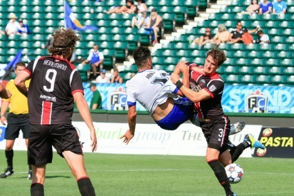 Ottawa's Mason Trafford brings down FCE's Frank Jonke at Commonwealth Stadium. PHOTO: TONY LEWIS