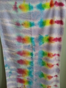 To get this look, I dipped half the towel in purple dye and used the bottle dyes in rainbow streaks on the other half.