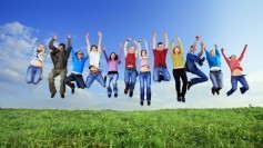 Big group of young people jumping with joy