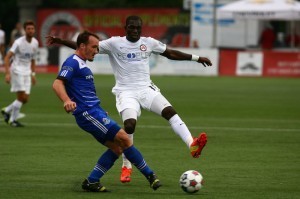 FCE's Albert Watson tries to keep the ball away from Atlanta's Kwadwo Poku.