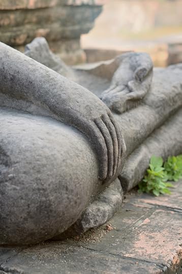 Detail of the hands of an ancient stone Buddha statue. © Natalia_Kalyatina via iStockphoto