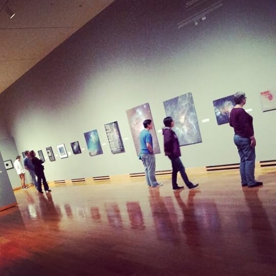 Workshop attendees examining art.