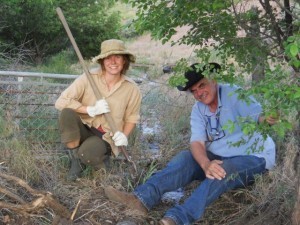 Peter Harris and Rivera Sun listen to the sound of the acequia (irrigation ditch) flowing sweetly toward Peter's field. Photo by Dariel Garner